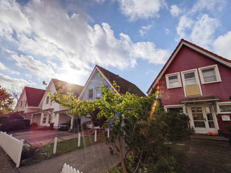 Houses in a row with blue sky and trees