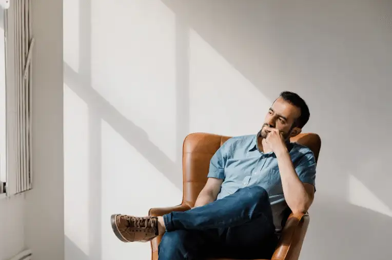 man sitting in chair thinking