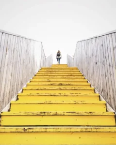 person climbing yellow steps